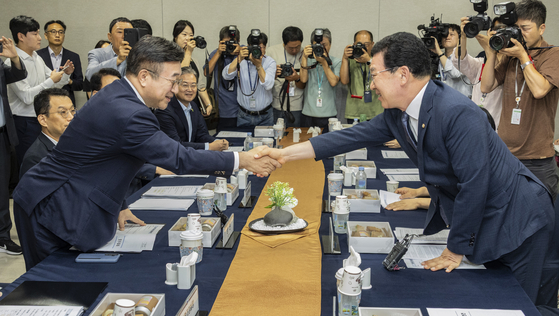 Interior and Safety Minister Yoon Ho-jung, left, shakes hands with Rep. Shin Jeong-hoon, chair of the National Assembly’s Interior and Safety Committee, during a meeting at the National Assembly in western Seoul on Sept. 2. [YONHAP] 