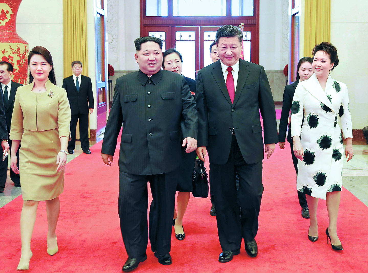 In this photo released by Pyongyang's state controlled Korean Central News Agency, North Korean leader Kim Jong-un, second from left, walks alongside Chinese President Xi Jingping inside the Great Hall of the People in Beijing on March 26, 2018, during his first visit to the Chinese capital. Kim's wife Ri Sol-ju is on the left, while Xi's wife Peng Liyuan is on the right. [YONHAP]