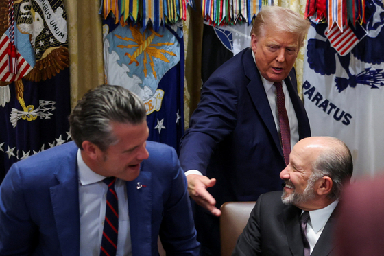 U.S. President Donald Trump leaves, following a Cabinet meeting, next to Defense Secretary Pete Hegseth and Secretary of Commerce Howard Lutnick, at the White House in Washington on Aug. 26. [REUTERS/YONHAP]