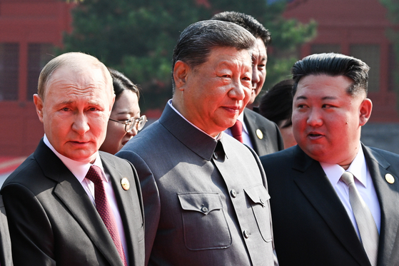 Russian President Vladimir Putin, Chinese President Xi Jinping and North Korean leader Kim Jong-un are seen ahead of a military parade marking the 80th anniversary of victory over the militarist Japan and the end of World War II in Beijing on Sept. 3. [TASS/YONHAP] 