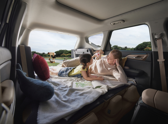 The EV5's second-row seats can fold flat, allowing users to extend the rear space seamlessly into the luggage area. [KIA]