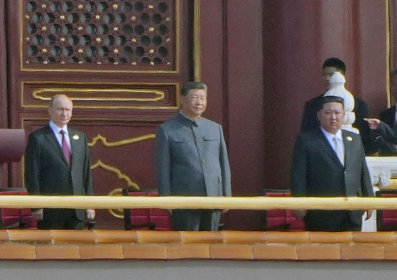 Russian President Vladimir Putin, Chinese President Xi Jinping and North Korean leader Kim Jong-un are seen during a military parade marking the 80th anniversary of victory over the militarist Japan and the end of World War II in Beijing on Sept. 3. [YONHAP]
