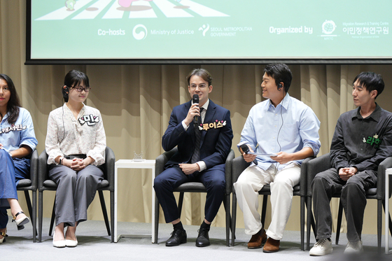 Ferreira Fraga Luis Filipe, center, a medical AI engineer, speaks as one of eight panelists during a roundtable on policies for foreign residents at City Hall in central Seoul on Sept. 4. [SEOUL METROPOLITAN GOVERNMENT]