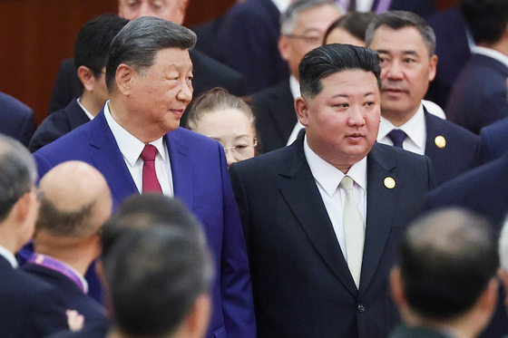 Chinese President Xi Jinping, left, and North Korean leader Kim Jong-un arrive for an official reception held at the Banquet Hall of the Great Hall of the People to mark the 80th anniversary of China's Victory Day on Sept. 3. [TASS/YONHAP] 