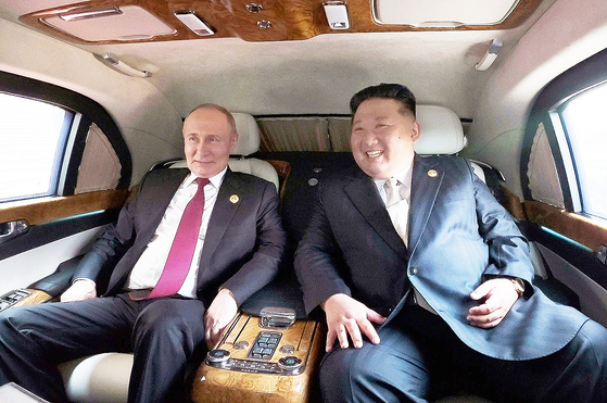 North Korean leader Kim Jong-un, right, and Russian President Vladimir Putin, left, right together in a vehicle in this photo released by the state-run Rodong Sinmun on Sept 4. [RODONG SINMUN]