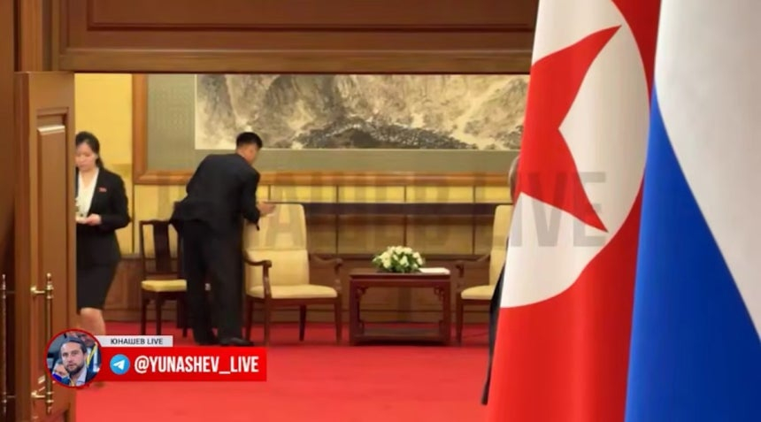 A North Korean aide wipes down the chair used by North Korean leader Kim Jong-un following his bilateral summit with Russian President Vladimir Putin in Beijing on Sept. 3. [SCREEN CAPTURE]