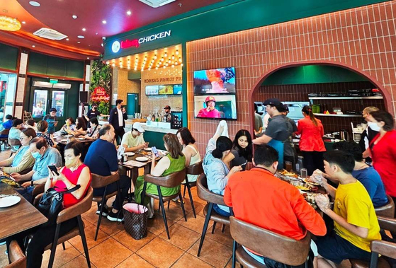 Customers eat fried chicken at a Genesis bbq store in the Philippines in this undated photo. [GENESIS BBQ]