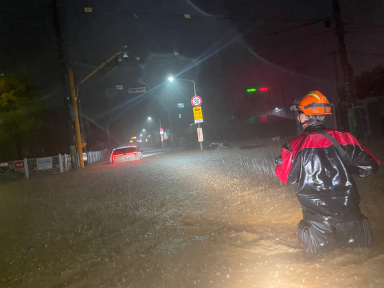 A firefighter is dispatched to a distress report in Gunsan, North Jeolla, as heavy rain hit the region in the early morning on Sept. 7. [JEONBUK FIRE DEPARTMENT]