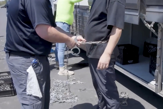 This image from video provided by U.S. Immigration and Customs Enforcement via DVIDS shows a person being handcuffed at the Hyundai Motor Group’s electric vehicle plant, Thursday, Sept. 4, 2025. [AP/YONHAP]