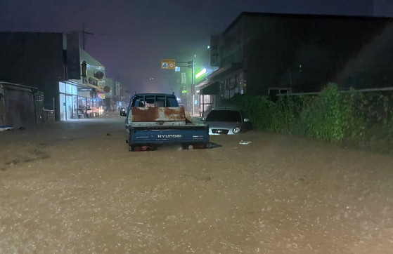 A truck is partially submerged in a flood as heavy rain hits the North Jeolla region in Gunsan in the early morning on Sept. 7. [JEONBUK FIRE DEPARTMENT]