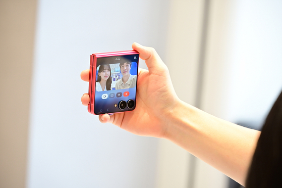 A customer tries out the new Galaxy Z Flip 7 at the Samsung Store Hongdae in Mapo District, western Seoul, on July 25. [SAMSUNG ELECTRONICS]