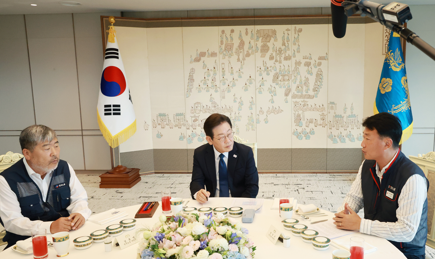 President Lee Jae Myung (center) listens to remarks by Kim Dong-myung (left), head of the Federation of Korean Trade Unions, and Yang Kyung-soo, head of the Korean Confederation of Trade Unions, during a luncheon meeting at the presidential office in Yongsan District, Seoul, on Sept. 4. [YONHAP]