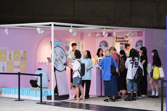 Attendees of Seoul Fashion Week 2026 Spring/Summer take part in an event at the booth of household goods brand Pigeon at Dongdaemun Design Plaza in Jung District, central Seoul, on Sept. 6. [SEOUL METROPOLITAN GOVERNMENT]