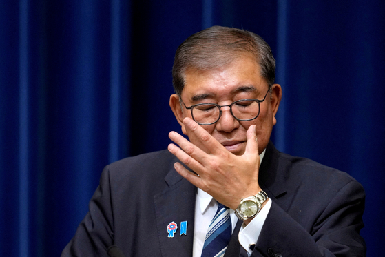 Japanese Prime Minister Shigeru Ishiba adjusts his glasses during a press conference as he announces his resignation, in Tokyo on Sept. 7. [REUTERS/YONHAP]