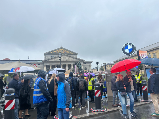 Visitors to the IAA Mobility 2025 wait in line to enter the BMW booth in Munich on Sept. 10. [SARAH CHEA]