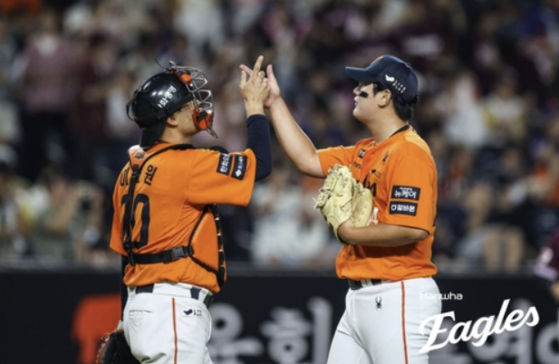 Hanwha Eagles closer Kim Seo-hyeon, right, celebrates with catcher Lee Jae-won after the Eagles beat the Kiwoom Heroes 10-5 in a KBO regular-season game at Daejeon Hanwha Life Ballpark in Daejeon on Sept. 13. [HANWHA EAGLES]