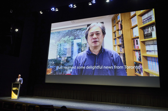 Director Park Chan-wook speaks in a prerecorded message as ″No Other Choice″ wins the 2025 TIFF International People's Choice Award during the Toronto International Film Festival's awards ceremony in Toronto on Sept. 14. [AP/YONHAP]