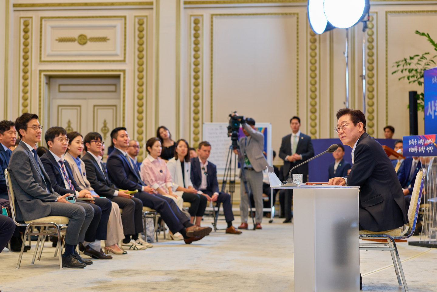 President Lee Jae Myung, right, speaks during a press conference to mark 100 days in office at the Blue House’s Yeongbingwan state guest house in central Seoul on Sept. 11. [PRESIDENTIAL OFFICE]