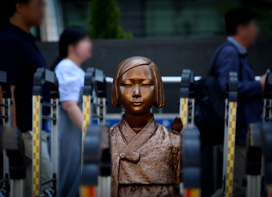 A statue of peace, depicting a young girl victimized by Japanese sexual slavery, is seen in front of a former building of the Japanese Embassy in Jongno District, central Seoul on Aug. 21. [YONHAP]