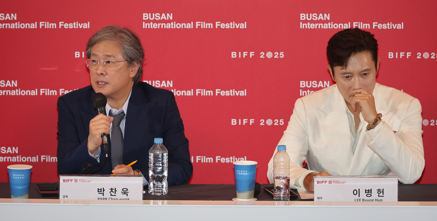 Director Park Chan-wook, left, speaks alongside actor Lee Byung-hun during a press conference for his latest film ″No Other Choice″ held at the Busan Cinema Center in Haeundae District on Sept. 17. The film was selected as the opener for this year's Busan International Film Festival. [SONG BONG-GEUN]