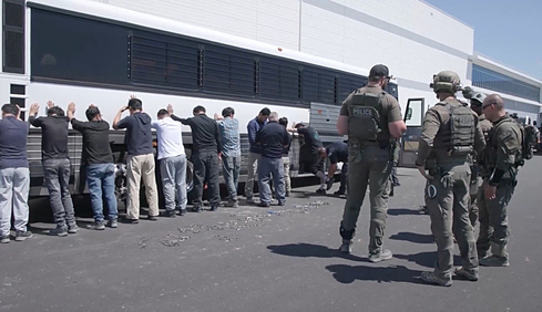 U.S. Immigration and Customs (ICE) agents restrain workers swept up in a raid at a battery plant construction site on charges of violating U.S. immigration rules in Georgia, on Sept. 4, in this video uploaded by ICE on Sept. 6. More than 300 Korean nationals were detained. [SCREEN CAPTURE]