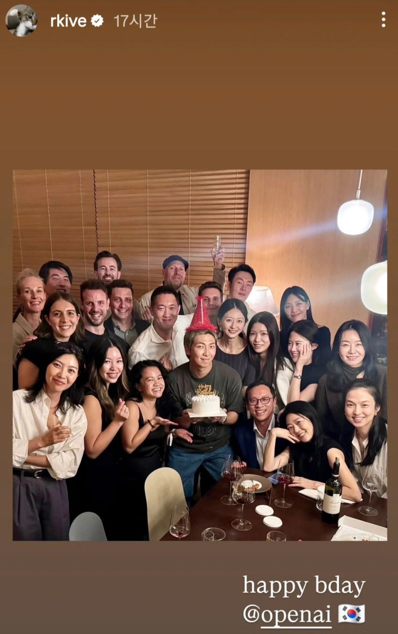 BTS's RM, center in the front row, poses for a photo with OpenAI executives at an unofficial event Sept. 11 marking the opening of the U.S. tech firm’s Korean branch. Participants also celebrated RM’s birthday, which falls Sept. 12. The photo was posted to RM’s Instagram Stories. [SCREEN CAPTURE]