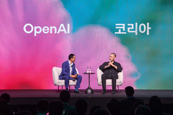 Producer Vince of The Black Label, right, who worked on the original soundtrack for Netflix's “KPop Demon Hunters,” speaks with Oliver Jay, OpenAI’s chief business officer, during the launch event for OpenAI Korea on Sept. 11. [OPENAI]