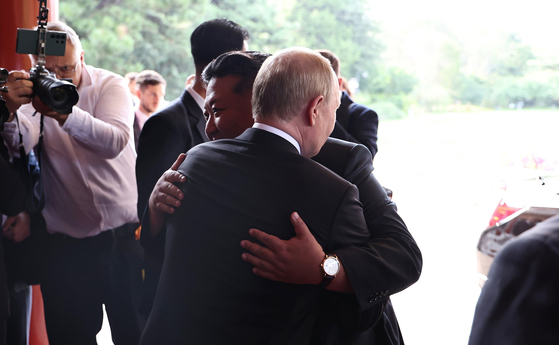 Russian President Vladimir Putin hugs North Korean leader Kim Jong-un after a meeting in Beijing on Sept. 3. The two leaders met during China's Victory Day celebrations held the same day. [UPI/YONHAP] 