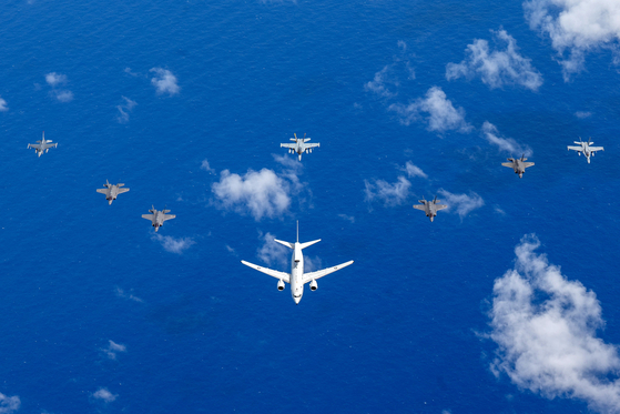 A Royal Australian Air Force E-7A Wedgetail electronic warfare (EW) aircraft, center, alongside a United States Navy EA-18G Growler, an EW aircraft based on the F/A-18F Super Hornet, flies over Guam on Feb. 10. [AFP/YONHAP]