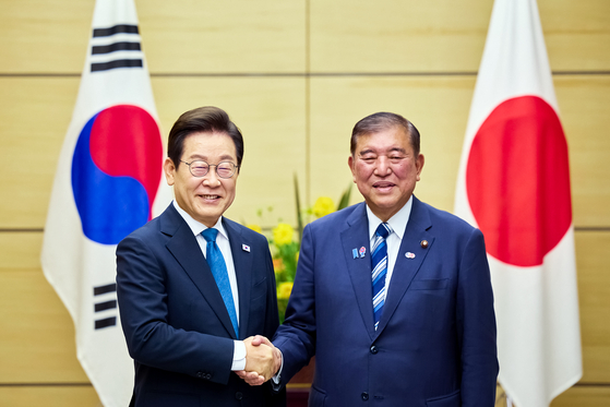 President Lee Jae Myung, left, and Japanese Prime Minister Shigeru Ishiba shake hands after their joint press briefing on the results of their bilateral summit at the prime minister's official residence in Tokyo on Aug. 23. [JOINT PRESS CORPS]