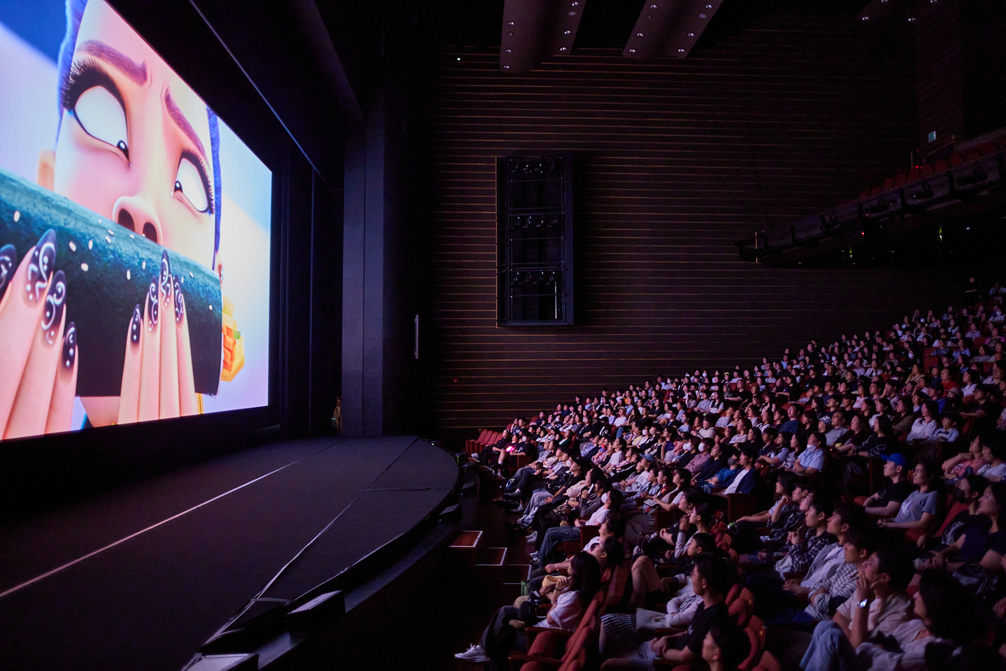 The audience watches Korea's first sing-along screening of Netflix's ″KPop Demon Hunters,″ held at Dongseo University Sohyang Theatre ShinhanCard Hall on Sept. 20. [BIFF]
