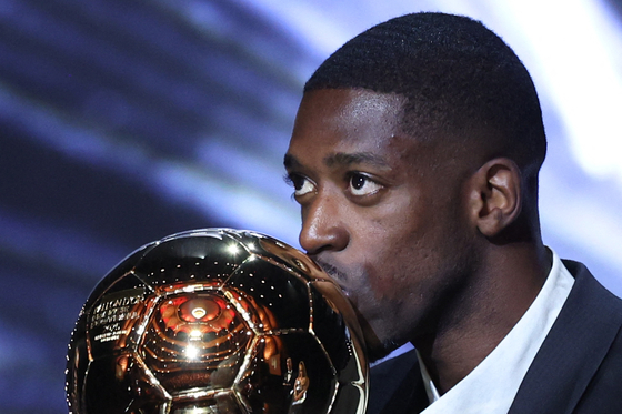 Paris Saint-Germain forward Ousmane Dembele kisses the Ballon d'Or award during the 2025 Ballon d'Or France Football award ceremony at the Theatre du Chatelet in Paris on Sept. 22. [AFP/YONHAP]