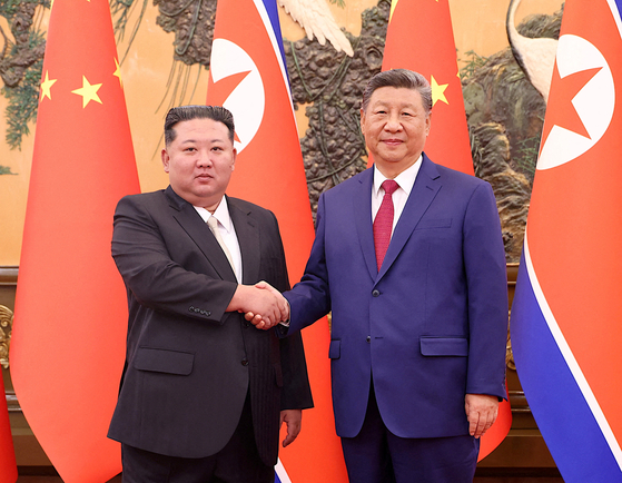 North Korean leader Kim Jong-un, left, shakes hands with Chinese President Xi Jinping at the Great Hall of the People in Beijing on Sept. 4. [CHINA DAILY/YONHAP] 