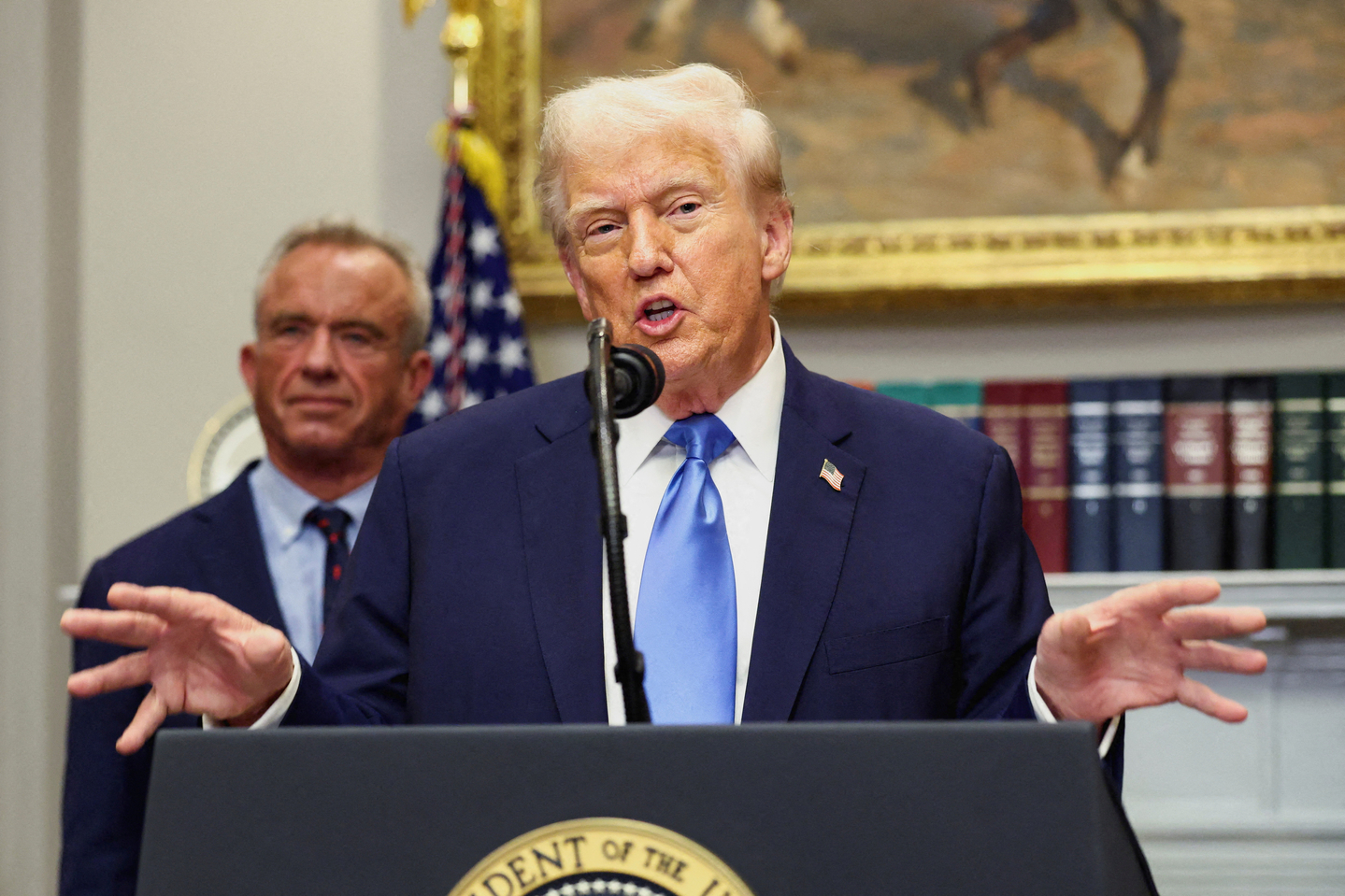 U.S. President Donald Trump, in front of U.S. Secretary of Health and Human Services Robert F. Kennedy Jr., delivers remarks linking autism to childhood vaccines and to the use of popular pain medication Tylenol bypregnant women and children, claims which are not backed by decades of science, at the White House in Washington on Sept. 22. [REUTERS/YONHAP]