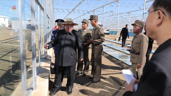 North Korean leader Kim Jong-un inspects the construction of the Sinuiju General Greenhouse Farm and regional development projects on Sept. 18. [KOREAN CENTRAL TELEVISION]