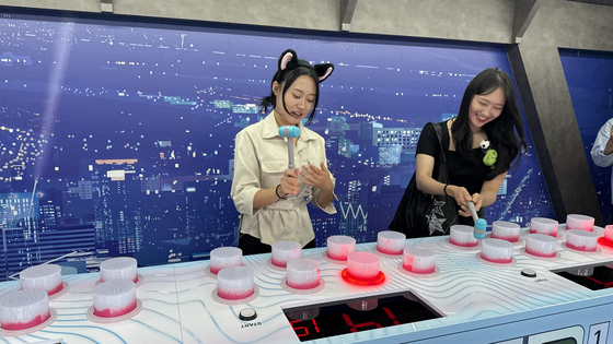 People play games at the HUNTR/X area in "KPop Demon Hunters" zone. [WOO JI-WON]