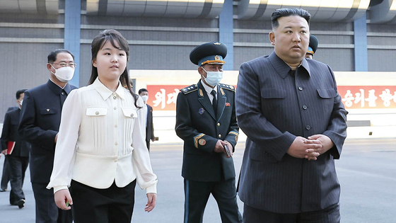 Kim Ju-ae, left in white, accompanies her father Kim Jong-un, to the National Aerospace Technology Administration on April 18, 2023. [RODONG SINMUN]