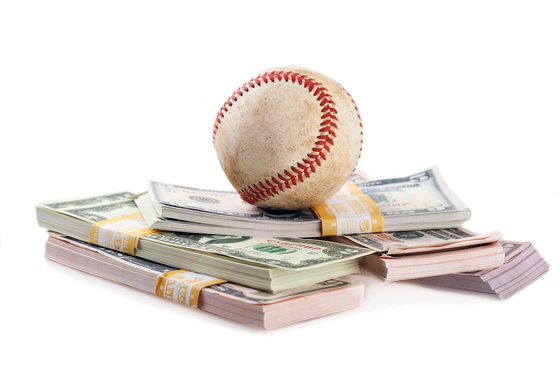 A baseball is seen with stacks of cash in this file photo. [GETTY IMAGES BANK]