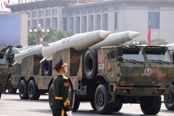 A member of the People's Liberation Army stands as a strategic strike group displays YJ-21 missiles during a military parade to mark the 80th anniversary of the end of World War II, in Beijing, China, Sept. 3, 2025. [REUTERS/YONHAP]