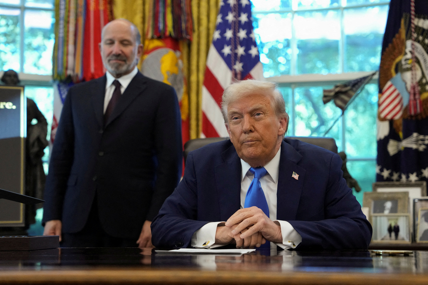 U.S. President Donald Trump looks on, with U.S. Secretary of Commerce Howard Lutnick standing by his side, in the Oval Office at the White House in Washington, D.C., U.S., on Sept.19. [REUTERS/YONHAP]