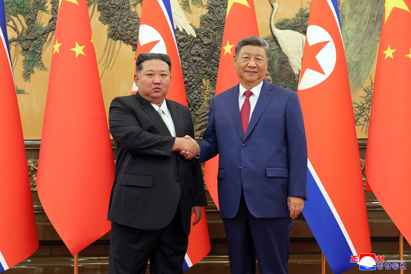 North Korean leader Kim Jong-un, left, shakes hands with Chinese President Xi Jinping during their talks on Sept. 4. [KCNA]