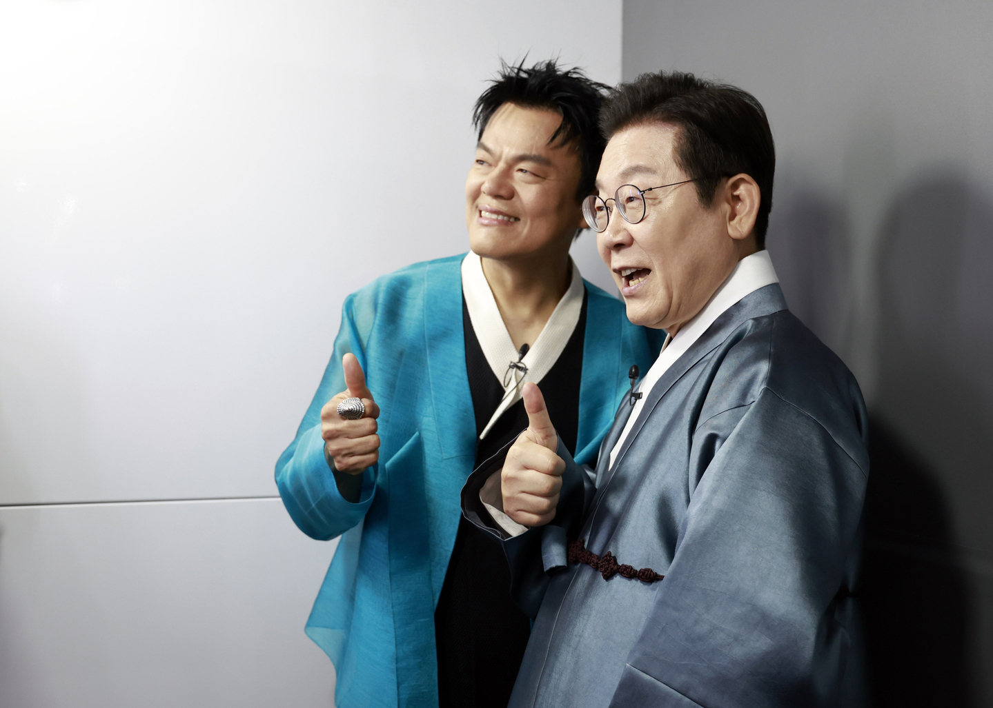 President Lee Jae Myung, right, and JYP Entertainment founder and co-chair of the newly established Presidential Committee on Popular Culture Exchange Park Jin-young pose for photos at the K-culture exhibition zone inside Kintex in Goyang, Gyeonggi, on Oct. 1. [JOINT PRESS CORPS]