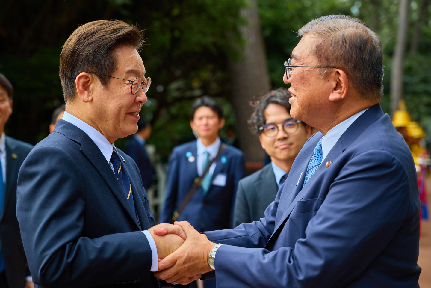 President Lee Jae Myung, left, greets Japanese Prime Minister Shigeru Ishiba at the Nurimaru APEC House in Busan ahead of their bilateral summit on Sept. 30. [PRESIDENTIAL OFFICE]