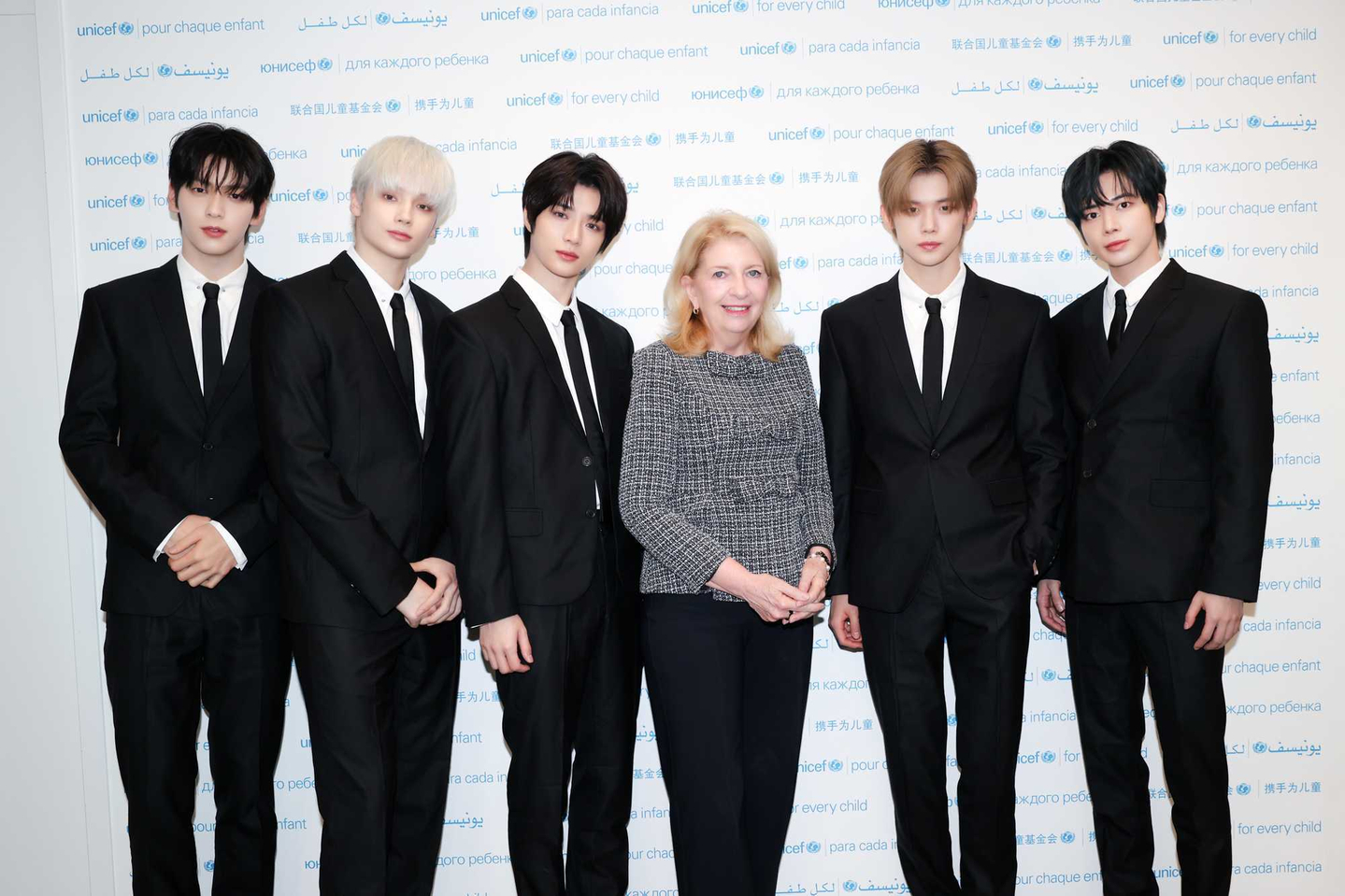 Boy band Tomorrow X Together poses with Unicef Executive Director Catherine Russell, third from right, during a campaign partnership event at the organization's headquarters in New York on Sept. 30. [UNICEF]