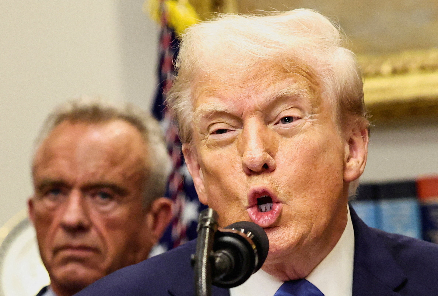 U.S. President Donald Trump, in front of U.S. Secretary of Health and Human Services Robert F. Kennedy Jr., delivers remarks claiming a link between autism and childhood vaccines and the use of the popular pain medication Tylenol for pregnant women and children, which has not been backed by decades of science, at the White House in Washington on Sept. 22.  [REUTERS/YONHAP] 