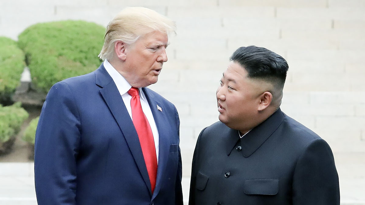 U.S. President Donald Trump, left, and North Korean leader Kim Jong-un cross into the South after greeting each other at the inter-Korean border village of Panmunjom on June 30, 2019. [YONHAP]