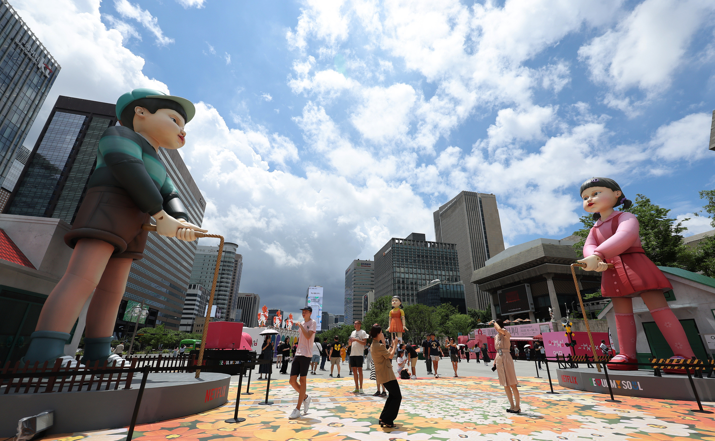 Visitors take photos of installations at a pop-up store for Season 3 of Squid Game in Gwanghwamun Plaza in Jongno District, central Seoul, on July 7. [NEWS1]