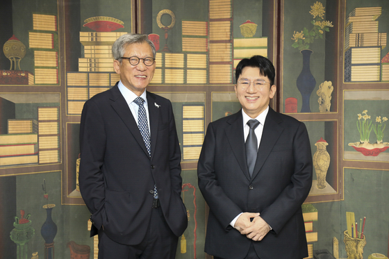 National Museum of Korea Director Yoo Hong-jun, left, and HYBE Chairman Bang Si-hyuk pose at the National Museum of Korea in central Seoul. This photograph was posted on the museum's social media accounts on Oct. 1, but was deleted the following day after backlash from the public. [HYBE]