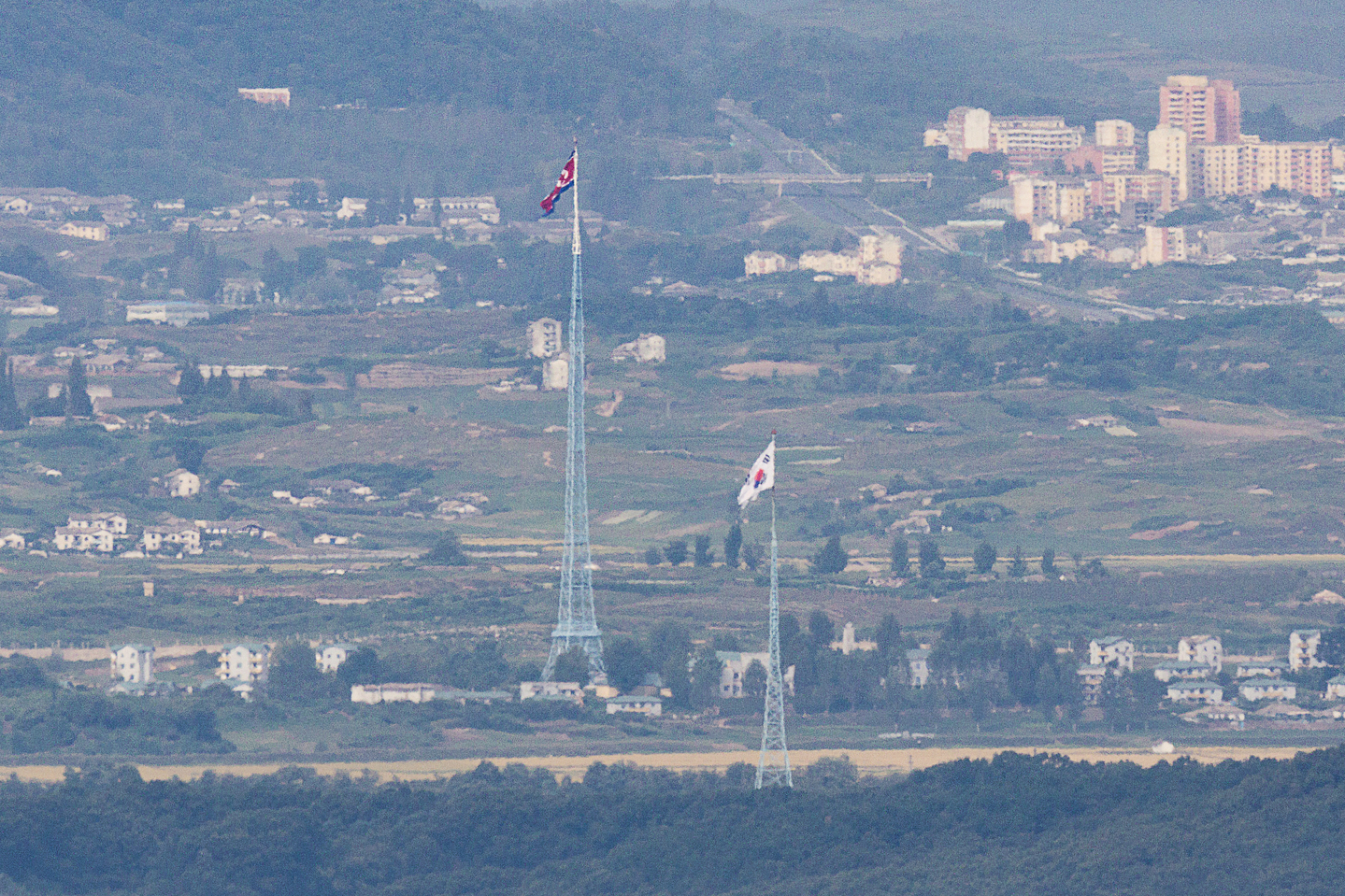 A South Korean flag in Daeseong-dong and a North Korean flag in Kijong-dong flutter in the western front of the demilitarized zone (DMZ) in Paju, Gyeonggi, on Sept. 22. South Korea is grappling with how to define its relationship with the North. [YONHAP]