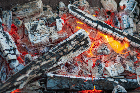 Logs burn in a metal oven in this file photo. [GETTY IMAGES BANK]